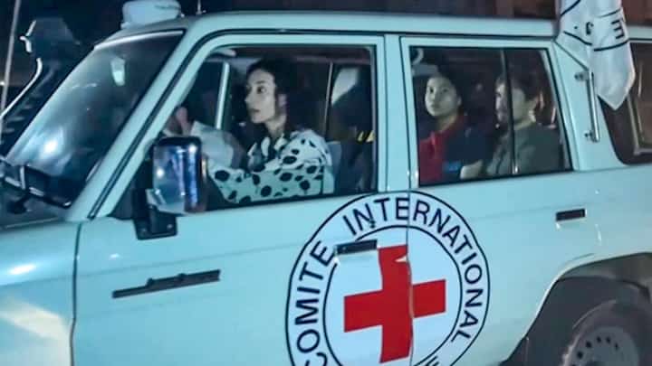 This image grab taken from an AFPTV video footage shows an International Red Cross vehicle reportedly carrying hostages released by Hamas crosses the Rafah border point in the Gaza Strip towards Egypt from where they would be flown to Israel to be reunited with their families, on 24 November 2023. Photo by Mahmud Hams / AFPTV / AFP