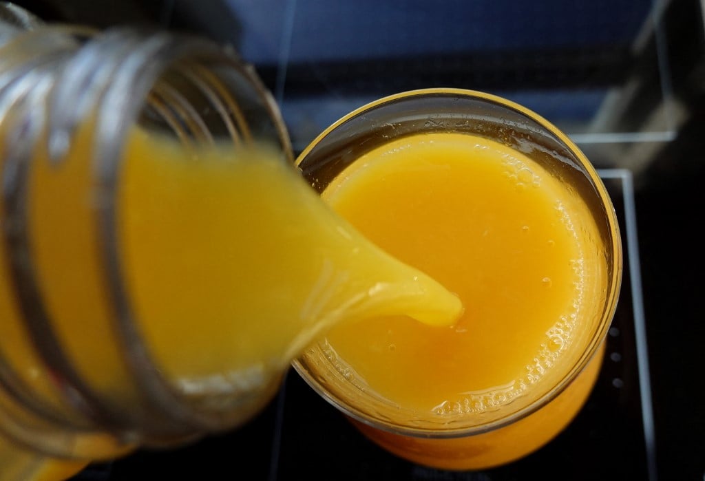 FILE PHOTO: In this photo illustration, orange juice is poured into a glass on 19 January 2023 in Miami, Florida. Orange juice has become expensive as Florida orange growers are harvesting their smallest crop in nearly 90 years, causing a short supply of oranges and driving up prices. (Photo Illustration by Joe Raedle/Getty Images)