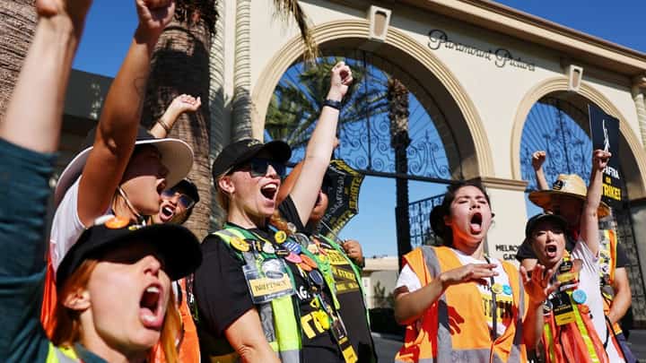 LOS ANGELES, CALIFORNIA - NOVEMBER 08: SAG-AFTRA members chant outside Paramount Studios on day 118 of their strike against the Hollywood studios on November 8, 2023 in Los Angeles, California. A tentative labor agreement has been reached between the actors union and the Alliance of Motion Picture and Television Producers (AMPTP) with the strike set to end after midnight. Mario Tama/Getty Images/AFP.