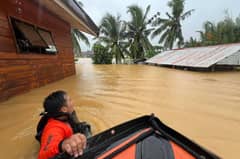 Rescuers used inflatable boats and ropes to reach people stranded in their houses in Northern Samar, one of the hardest hit provinces, where villages and towns have been inundated after a week of rain. Photo: handout / Philippine Coast Guard / AFP)
