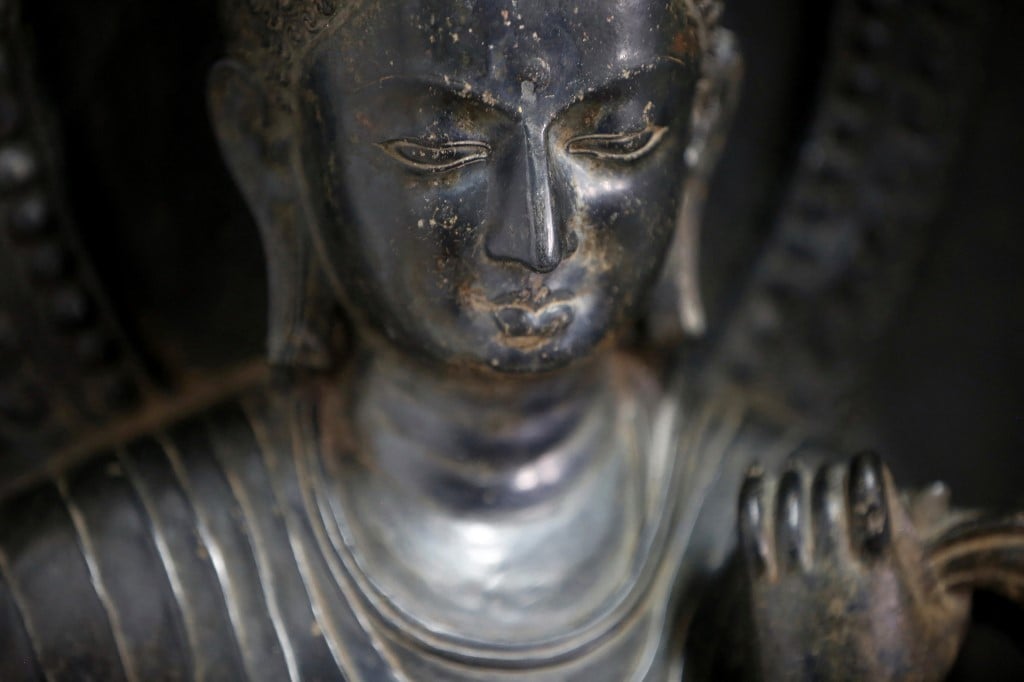 FILE PHOTO: A 700-year-old standing statue of the Buddha that was returned to Nepal from New York's Metropolitan Museum of Art is pictured in its delivery crate at the Department of Archaeology in Kathmandu on 4 April 2018. (Photo by Gopen RAI / AFP)