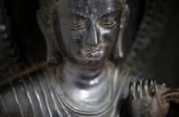 FILE PHOTO: A 700-year-old standing statue of the Buddha that was returned to Nepal from New York's Metropolitan Museum of Art is pictured in its delivery crate at the Department of Archaeology in Kathmandu on 4 April 2018. (Photo by Gopen RAI / AFP)