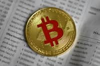 FILE PHOTO: The photo shows a physical imitation of a Bitcoin in Dortmund, western Germany. (Photo by INA FASSBENDER / AFP)