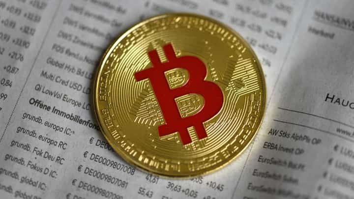 FILE PHOTO: The photo shows a physical imitation of a Bitcoin in Dortmund, western Germany. (Photo by INA FASSBENDER / AFP)