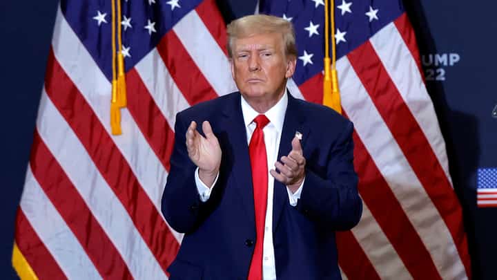 (FILES) Former US President and 2024 presidential hopeful Donald Trump applauds at the end of a campaign event in Waterloo, Iowa, on 19 December 2023.