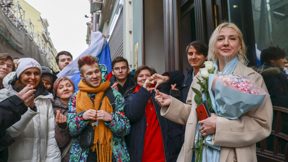 YEKATERINA Duntsova (right), a 40-year-old independent politician who declared her intention to run in the 2024 presidential election, holds flowers and poses with supporters outside the Central Election Commission in Moscow. | ARDEN ARKMAN/AGENCE FRANCE-PRESSE