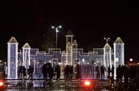 Syrians walk past Christmas decorations at a market in the capital Damascus on 23 December 2023. (Photo by LOUAI BESHARA / AFP)