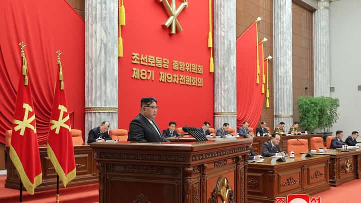 This undated picture released by North Korea's official Korean Central News Agency (KCNA) via KNS on 31 December 2023 shows North Korean leader Kim Jong Un (C) speaking at the 9th Plenary Session of the 8th Central Committee of the Workers' Party of Korea (WPK) at the Party's Central Committee headquarters building in Pyongyang. (Photo by KCNA VIA KNS / AFP) / - South Korea OUT / REPUBLIC OF KOREA OUT