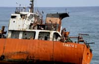 FILE PHOTO: A picture taken on 12 May 2016 shows an empty oil tanker that drifted onto the beach in Robertsport, western Liberia. (Photo by ZOOM DOSSO / AFP)