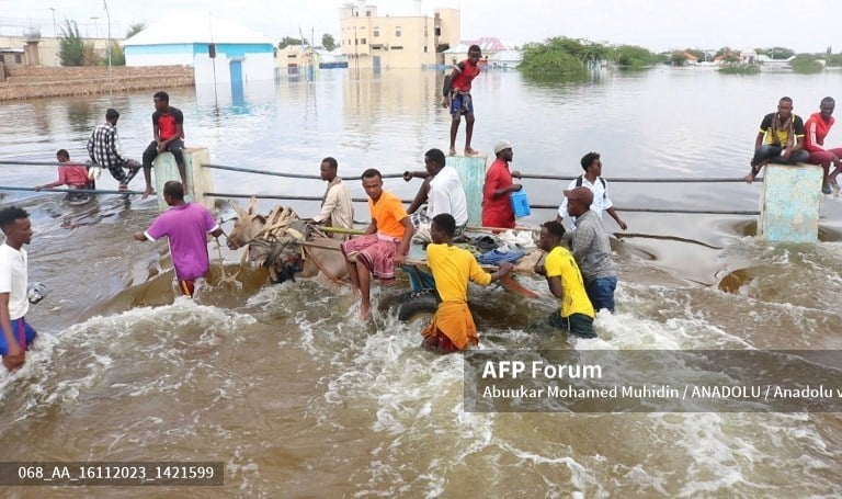 HIRAN, SOMALIA - NOVEMBER 15: People wade through a submerged street on a residential area in Beledweyne city of Hiran region on November 15, 2023 as Somalia is experiencing the worst climate-change-related floods in a century, wreaking havoc in many parts of the Horn of Africa country, affecting 1.24 million people and displacing over 456,800 more since the first week of October. Abuukar Mohamed Muhidin / Anadolu (Photo by Abuukar Mohamed Muhidin / ANADOLU / Anadolu via AFP)