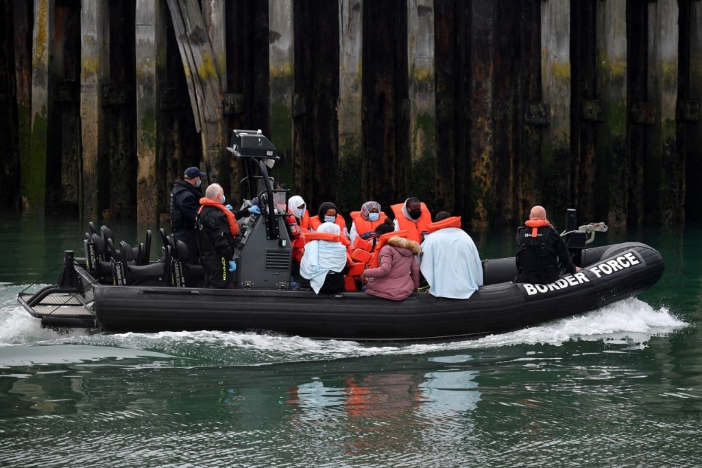 FILE PHOTO: UK Border Force officials travel in a RIB with migrants picked up at sea whilst Crossing the English Channel, as they arrive at the Marina in Dover, southeast England on 15 August 2020. (Photo by Ben STANSALL / AFP)