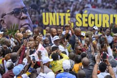 President Felix Tshisekedi (C) greets supporters after the announcement of the election results at QG Fatshi 20, the headquarters of his electoral campaign, in Gombe, Kinshasa, on 31 December 2023. Tshisekedi has won a second term in office, according to provisional results announced by the country's electoral commission. (Photo by Arsene Mpiana / AFP)