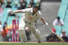 Australia's David Warner runs between the wickets to reach his half century (50 runs) during day four of the third cricket Test match between Australia and Pakistan at the Sydney Cricket Ground in Sydney on 6 January 2024. (Photo by Saeed KHAN / AFP)