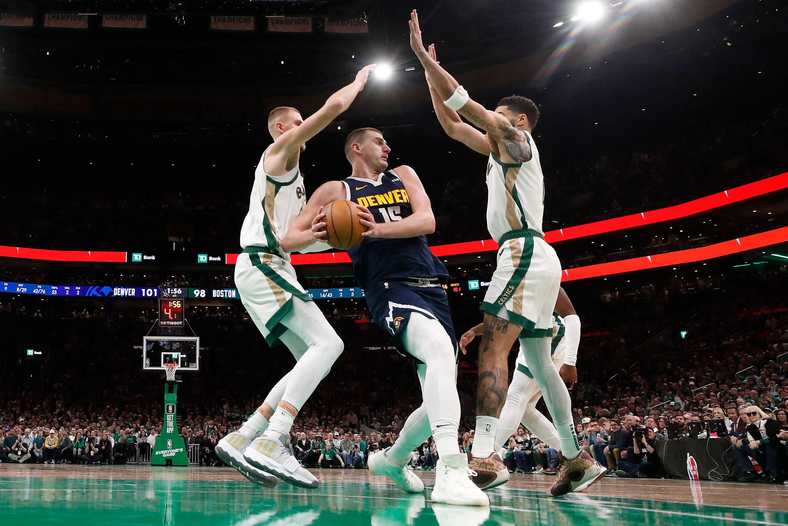 Denver’s Nikola Jokic gets double-teamed by the Boston duo of Kristaps Porzingis and Jayson Tatum but the Nuggets still edge the Celtics, 102-100, in their NBA regular season game. | WINSLOW TOWNSON/AGENCE FRANCE-PRESSE