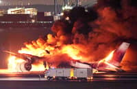 FLAMES engulf a Japan Airlines plane at the runway of Haneda Airport on Tuesday, 2 January, after apparently colliding with a Coast Guard aircraft. Five of the six crew members of the Coast Guard plane died, while all 379 aboard the JAL flight survived. | JIJI PRESS VIA STR/AGENCE FRANCE-PRESSE
