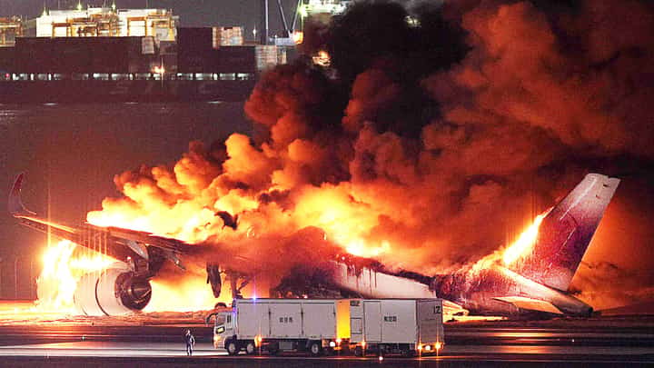 FLAMES engulf a Japan Airlines plane at the runway of Haneda Airport on Tuesday, 2 January, after apparently colliding with a Coast Guard aircraft. Five of the six crew members of the Coast Guard plane died, while all 379 aboard the JAL flight survived. | JIJI PRESS VIA STR/AGENCE FRANCE-PRESSE