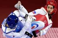 South Korea's Jang Jun (Blue) and Philippines' Kurt Bryan Barbosa (Red) compete in the taekwondo men's -58kg elimination round bout during the Tokyo 2020 Olympic Games at the Makuhari Messe Hall in Tokyo on July 24, 2021.