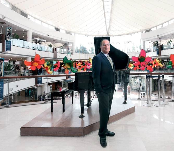 Arjun Sharma, director, Select CityWalk in Delhi, with the mall’s central atrium, decorated for spring, in the background.