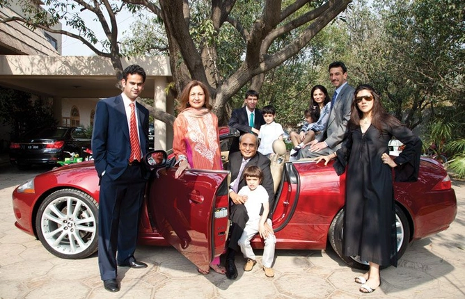 Mian Mansha with his sons and their families, in his Jaguar E-class convertible, outside the family home in Lahore.