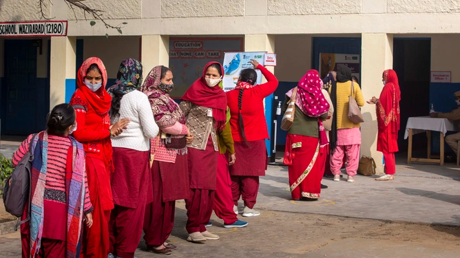 Health workers wait for their turn outside a Covid-19 vaccination centre in Gurugram.