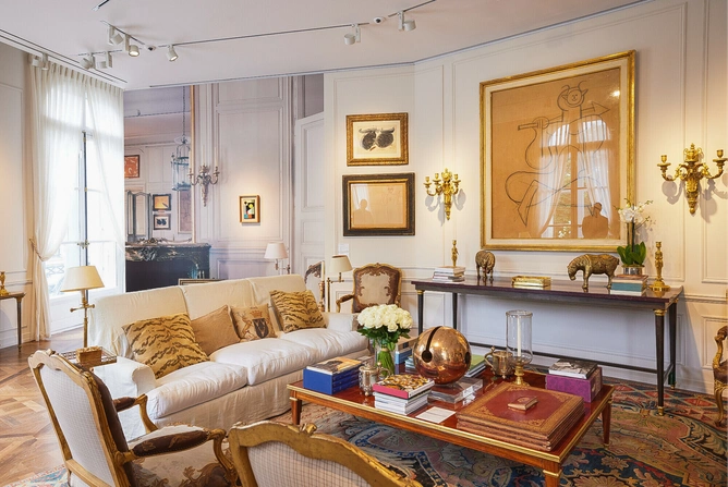 The living room of Hubert de Givenchy in his Paris house, the Hôtel d’Orrouer, where his brass figurines, a Picasso drawing, and tiger print cushions can be seen.