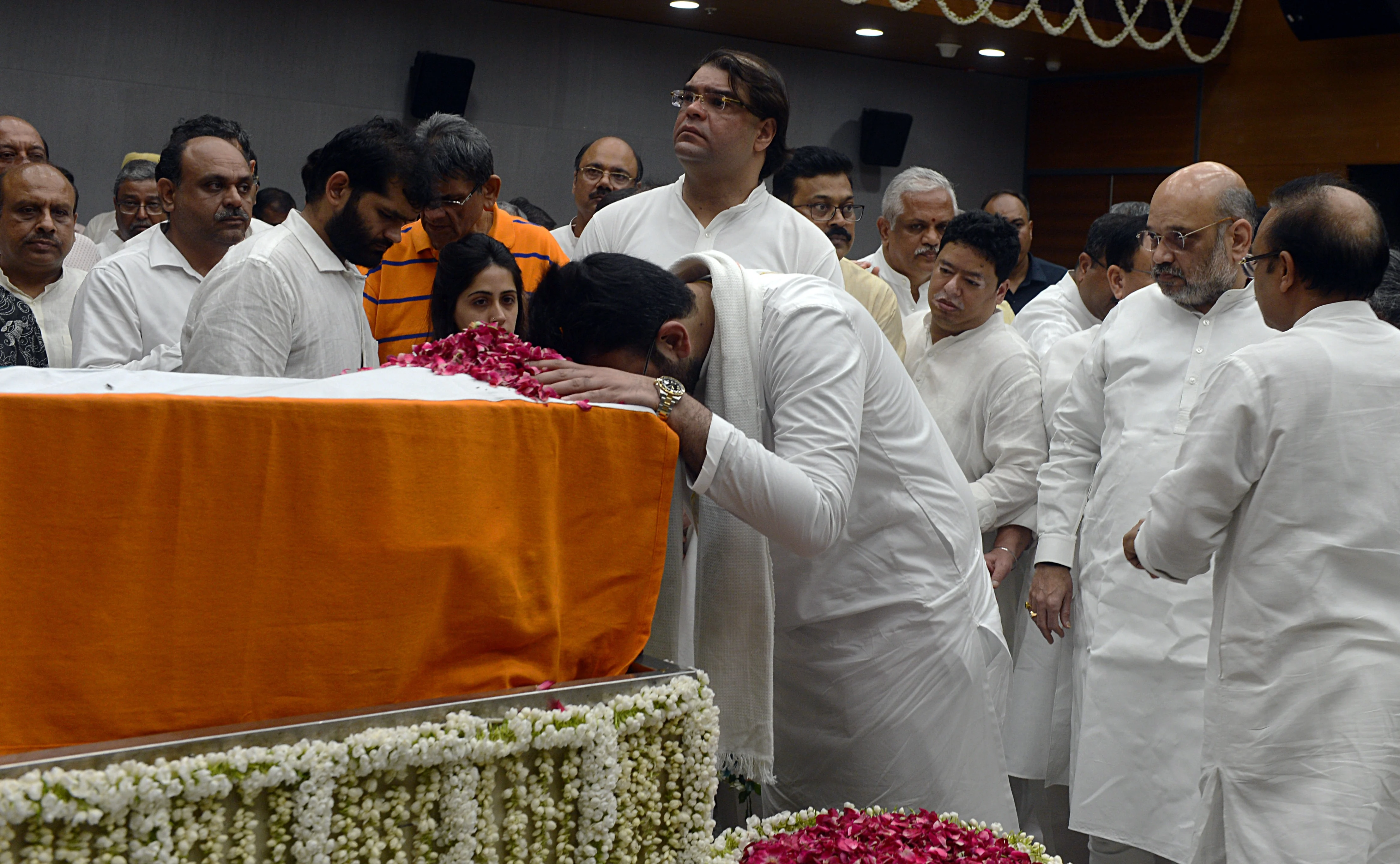 Rohan Jaitley son of former Finance Minister Arun Jaitley pays tributes during his last respects as Union Home Minister Amit Shah looks on at BJP headquarters in New Delhi