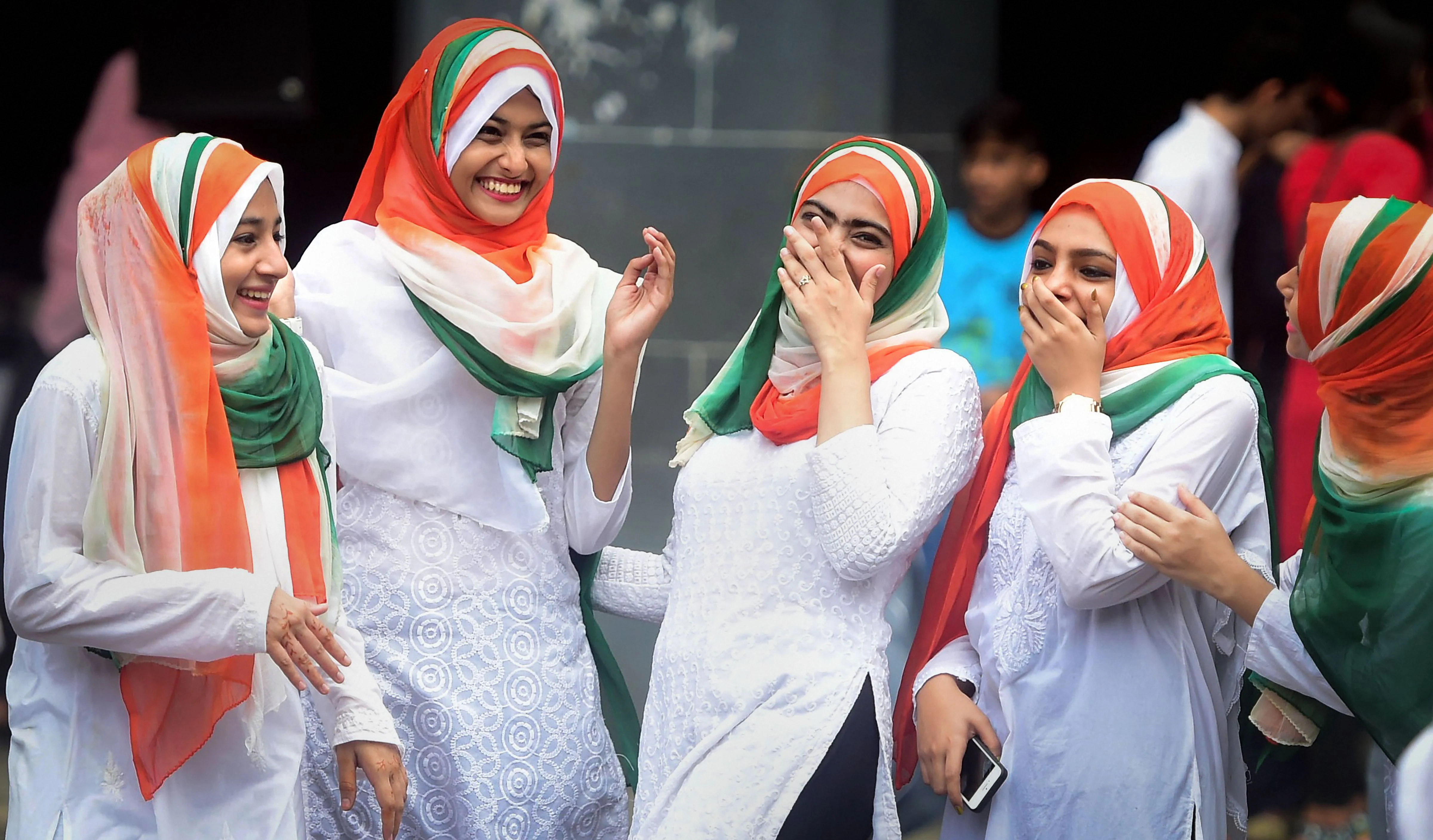 Students from the Anjuman Islam school share a light moment as they take part in the 73rd Independence Day celebrations, in Mumbai