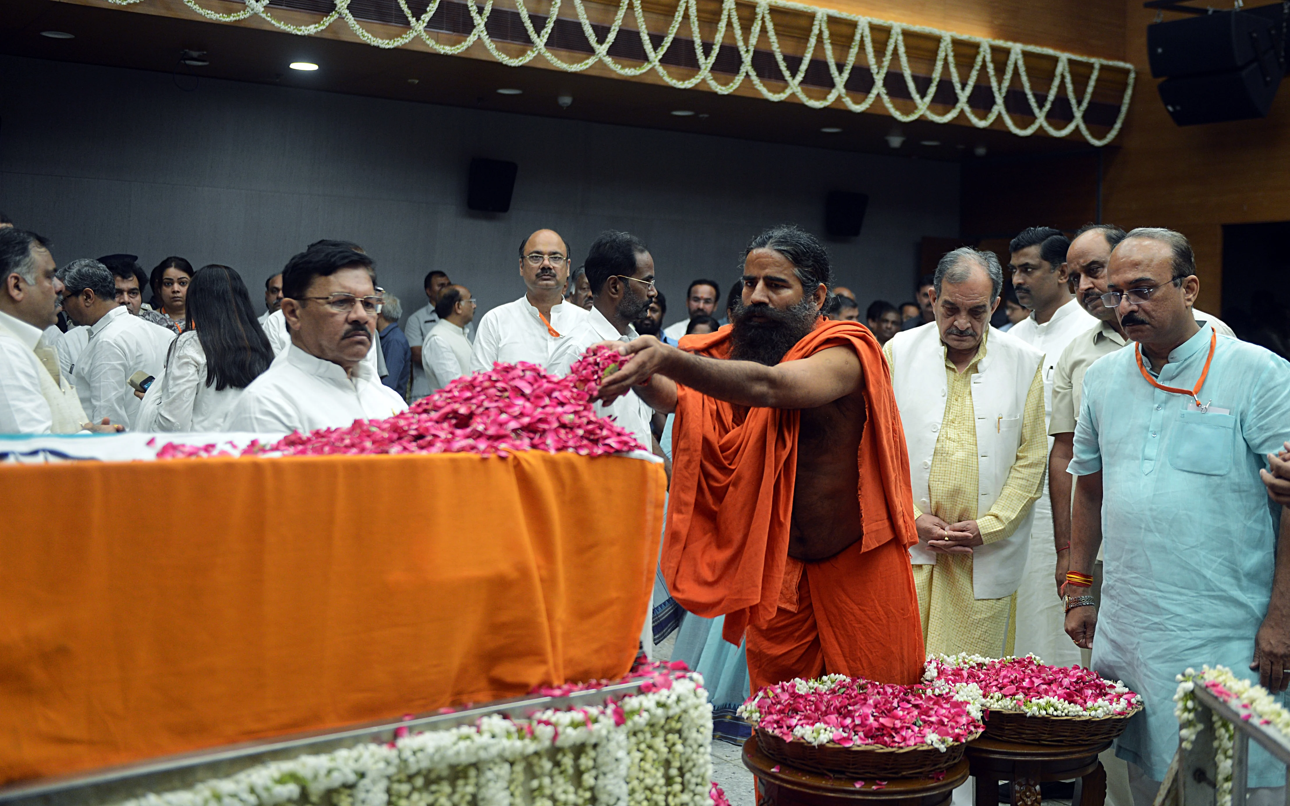 Yoga Guru Baba Ramdev pays floral tributes during the last respects of former Finance Minister Arun Jaitley at BJP headquarters in New Delhi