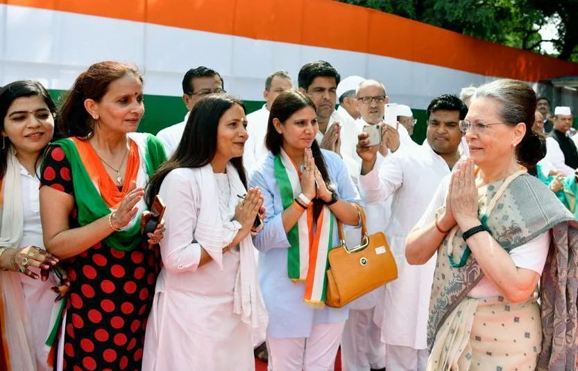 Congress Interim President Sonia Gandhi greets people during the celebration of 73rd Independence Day at AICC Headquarters in New Delhi