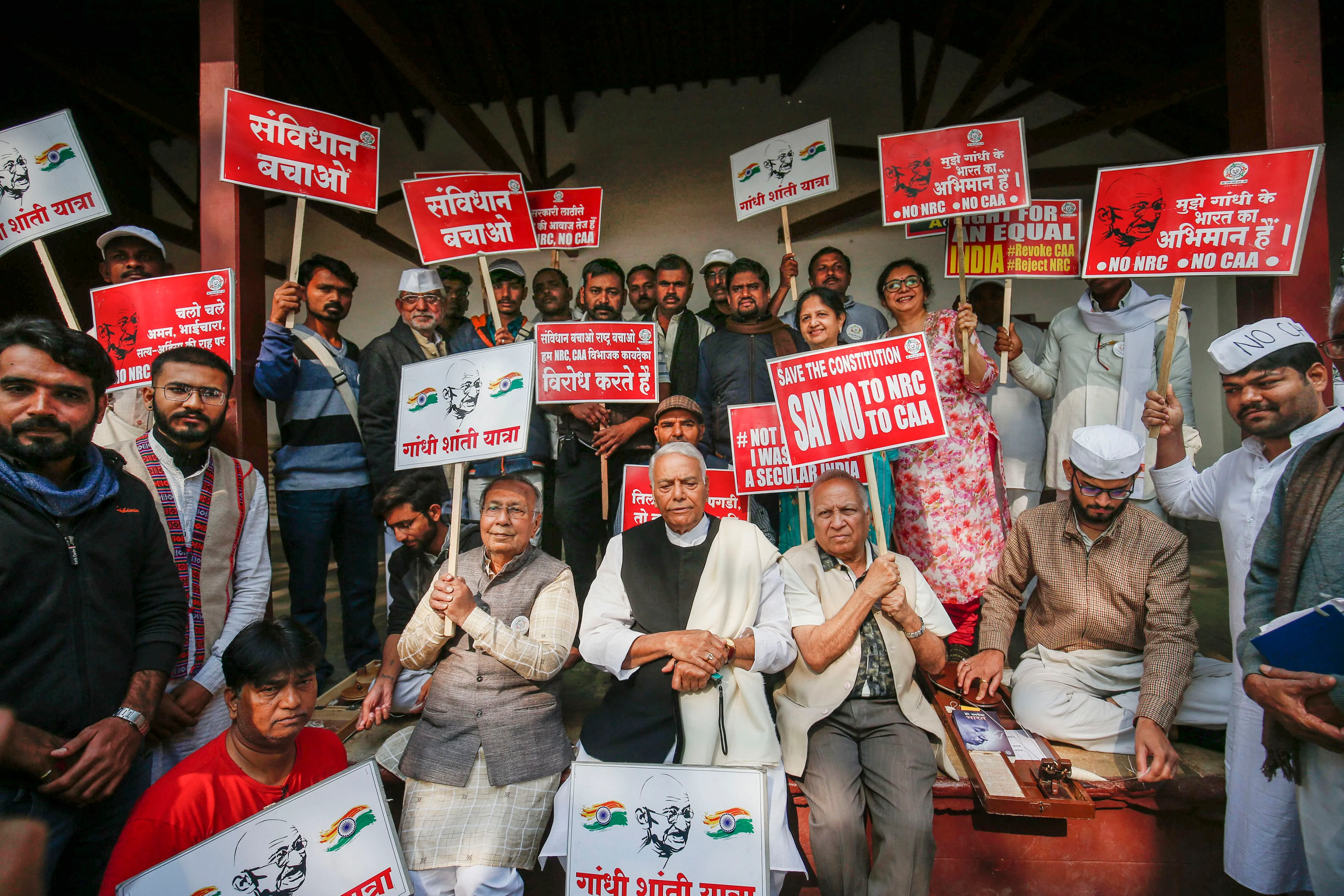 BJP leader and former Union minister Yashwant Sinha (C) with former Gujarat CM Suresh Mehta (L) and others leaders at a sit-in protest against the Citizenship Amendment Act and National Register of Citizens (NRC) during his 'Gandhi Shanti Yatra' in Ahmedabad, Saturday, Jan. 18, 2020.