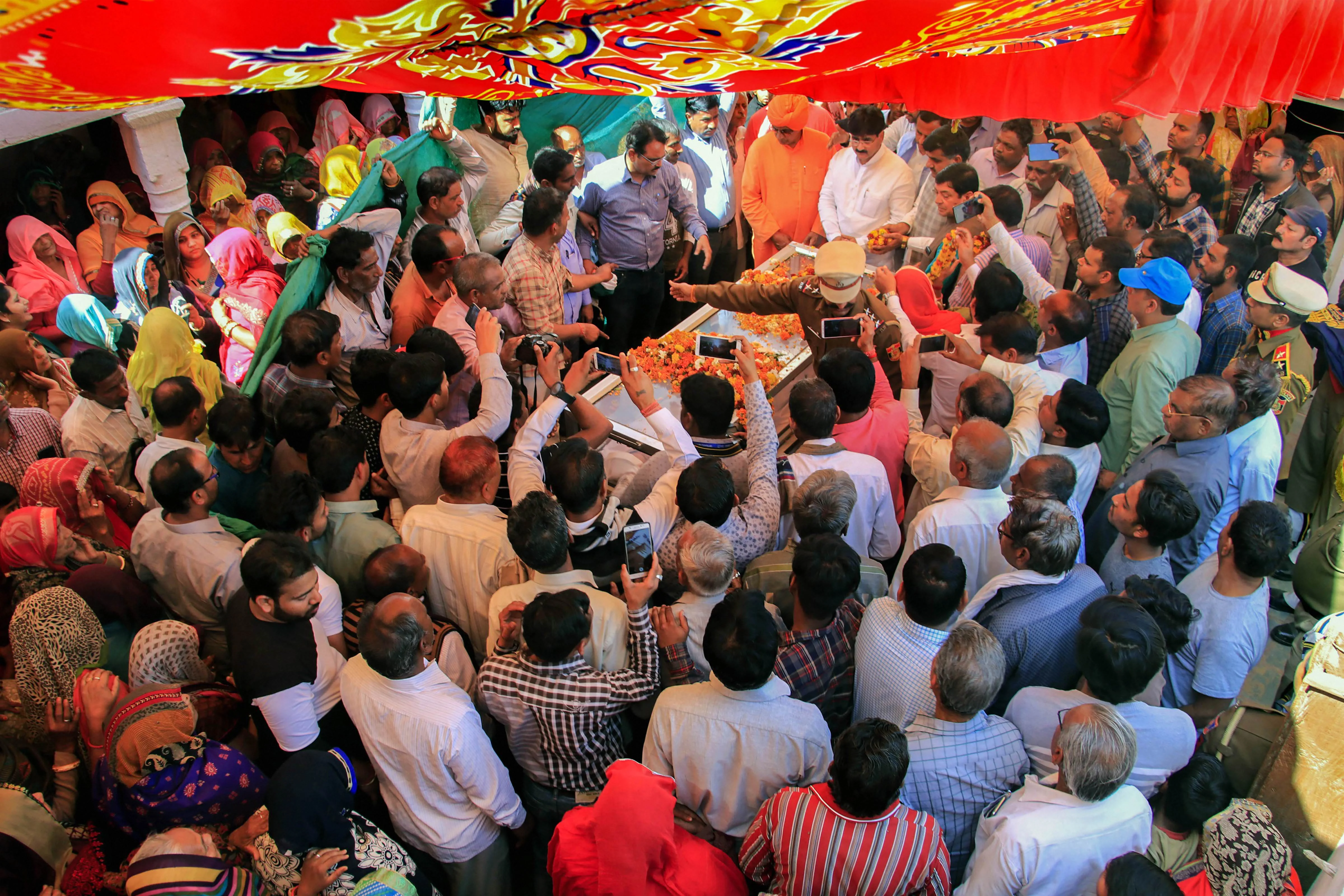 People pay their last respects to the mortal remains of slain Delhi police head constable Ratan Lal, who was killed during communal riots over the amended citizenship law in east Delhi area, in Sikar district of Rajasthan, Wednesday, Feb. 26, 2020.