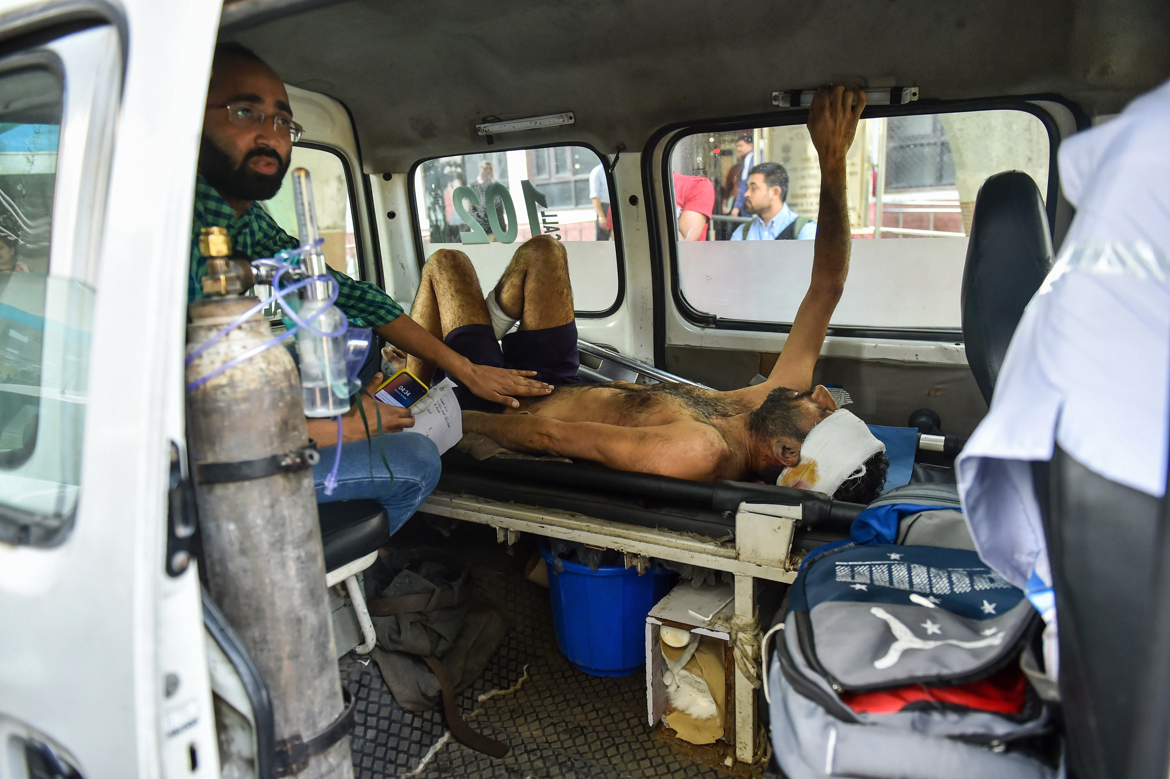 A man injured during communal violence over the amended citizenship law in the riot-affected north east Delhi, being brought to GTB hospital for treatment, in east Delhi, Wednesday, Feb. 26, 2020.