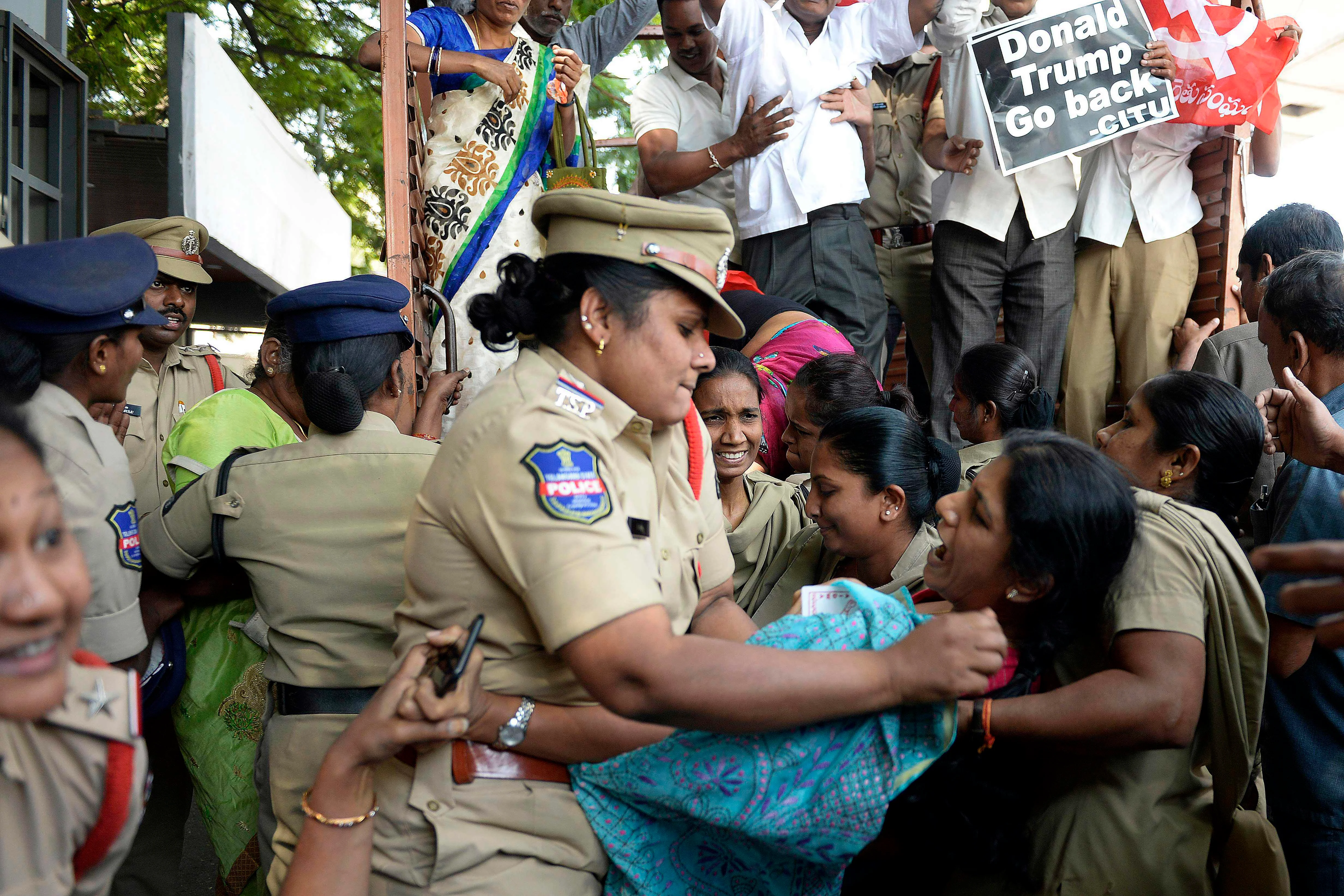 Police personnel detain an activist of the Centre of Indian Trade Unions (CITU) during a protest against US President Donald Trump's visit to India in Hyderabad on February 24, 2020