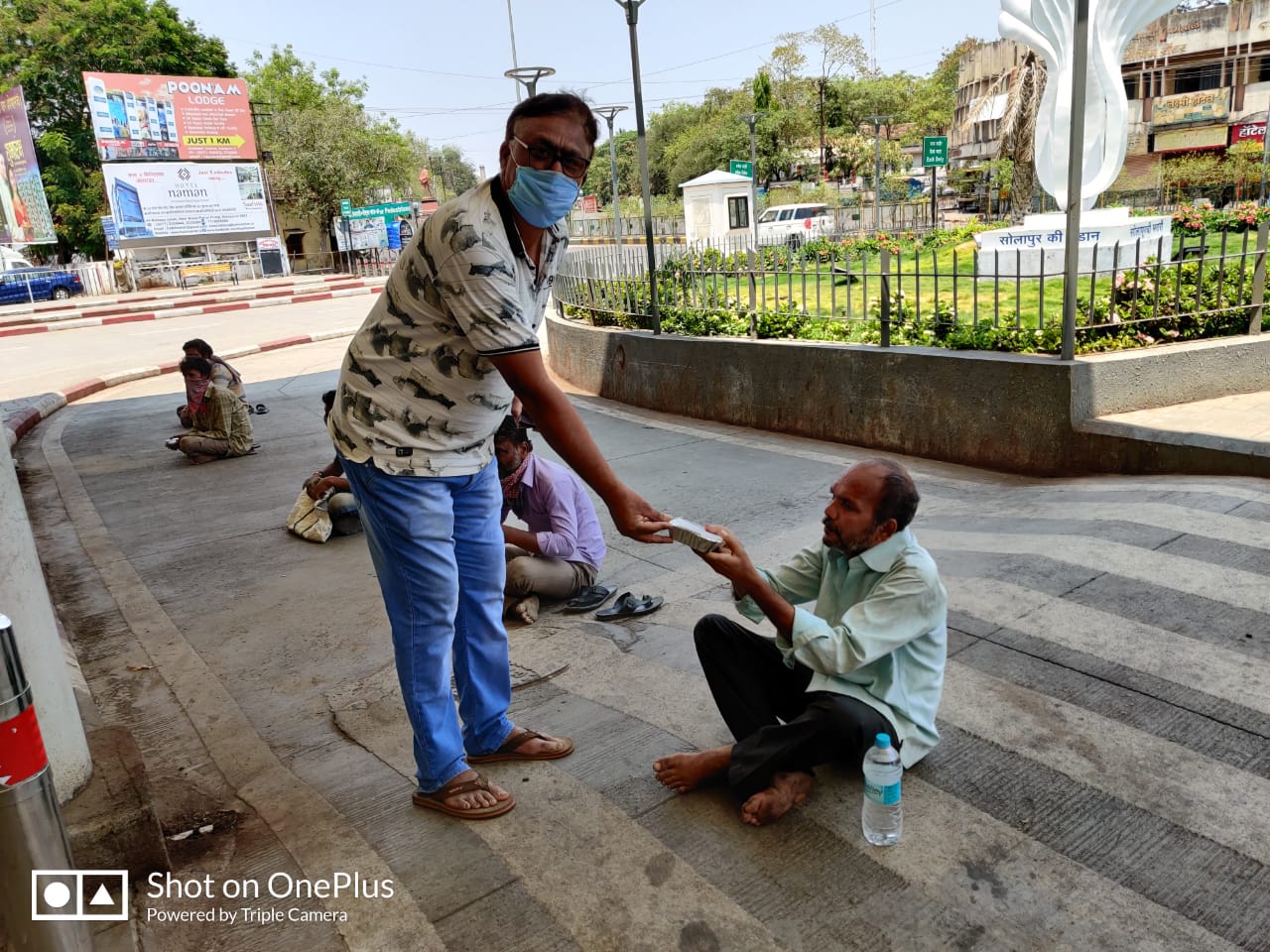 A man distributing food to the needy ones.