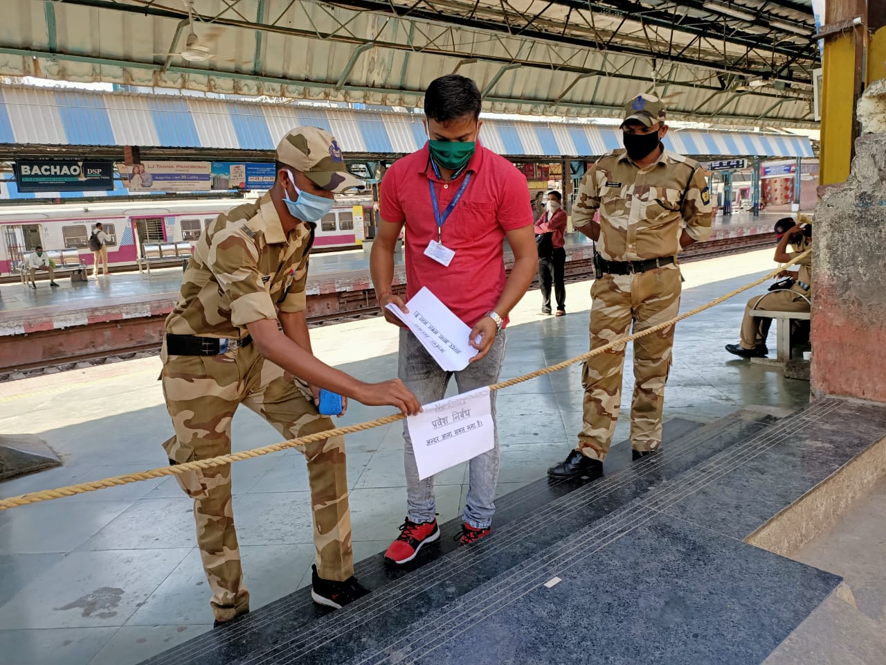 CRPF personnel putting up board for restricting entry in Mumbai railway stations and trains.