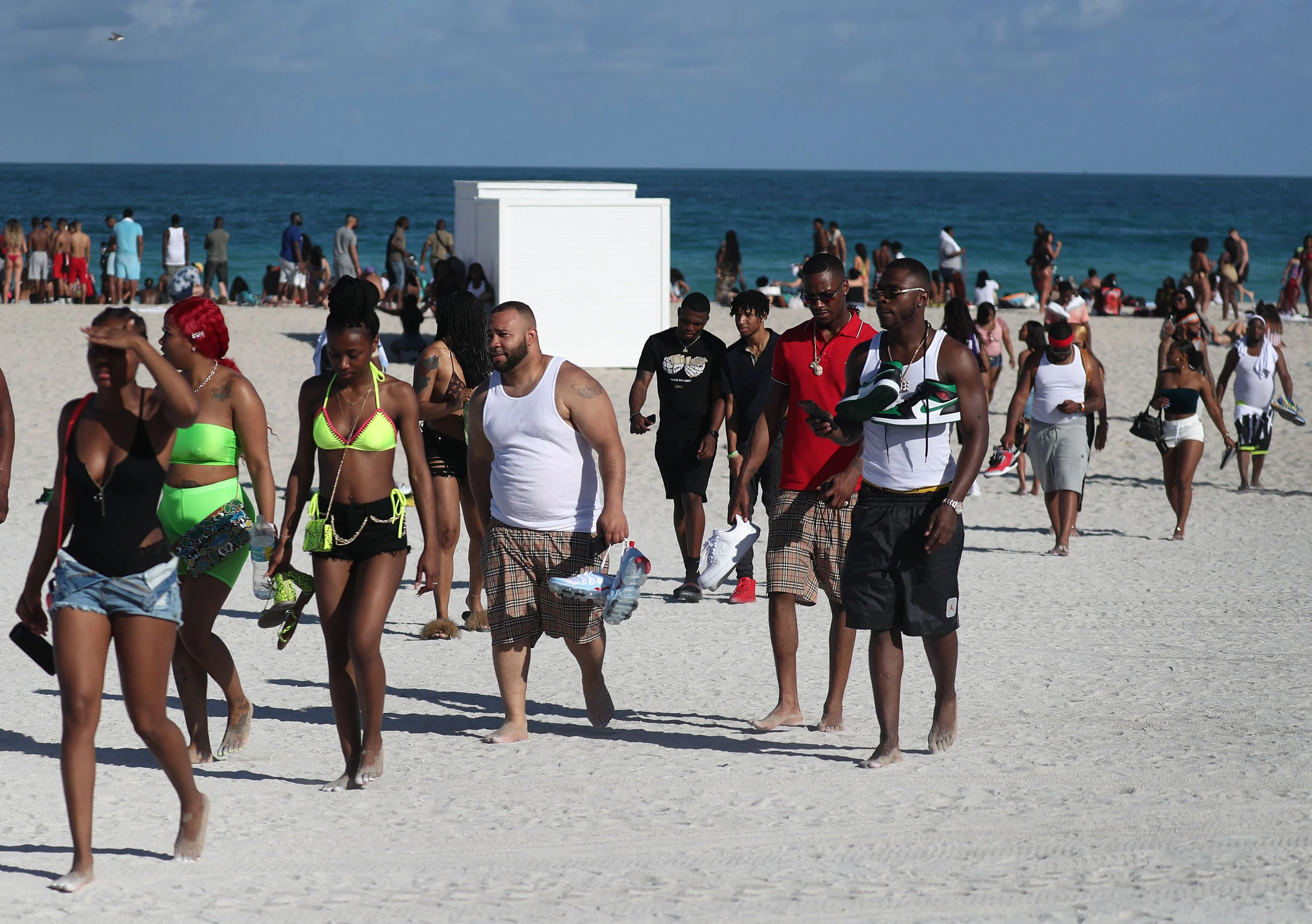 Tourists relax on the beach in Miami Beach, Florida.