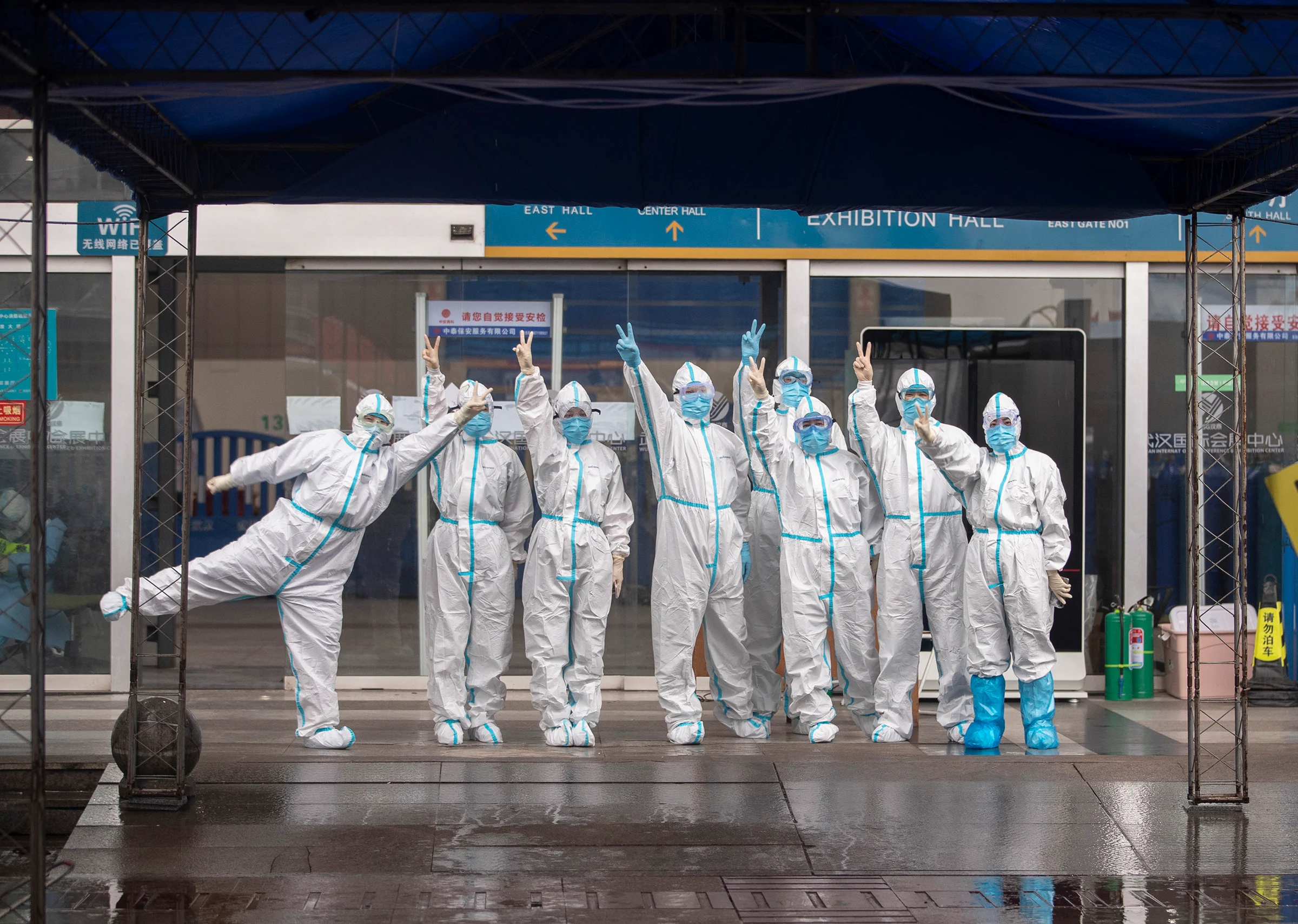The last batch of medical workers poses for a photo after walking out of the temporary hospital of Jianghan, in Wuhan, capital of central China's Hubei Province, March 9, 2020.