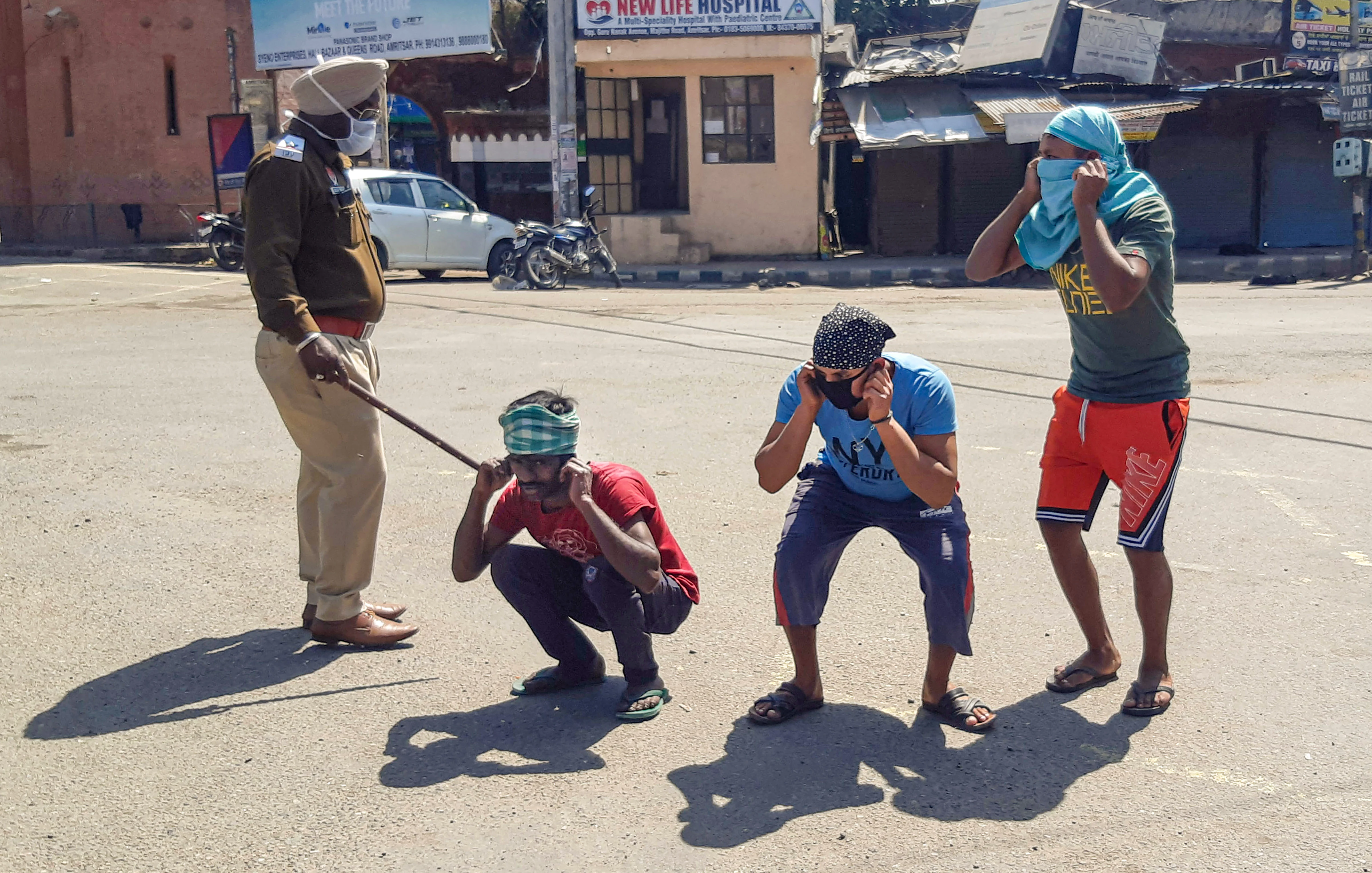 Police punish offenders for flouting the lockdown guidelines, on the first day of the 21-day nationwide lockdown, in the view of coronavirus pandemic, in Amritsar, Wednesday, March 25, 2020.