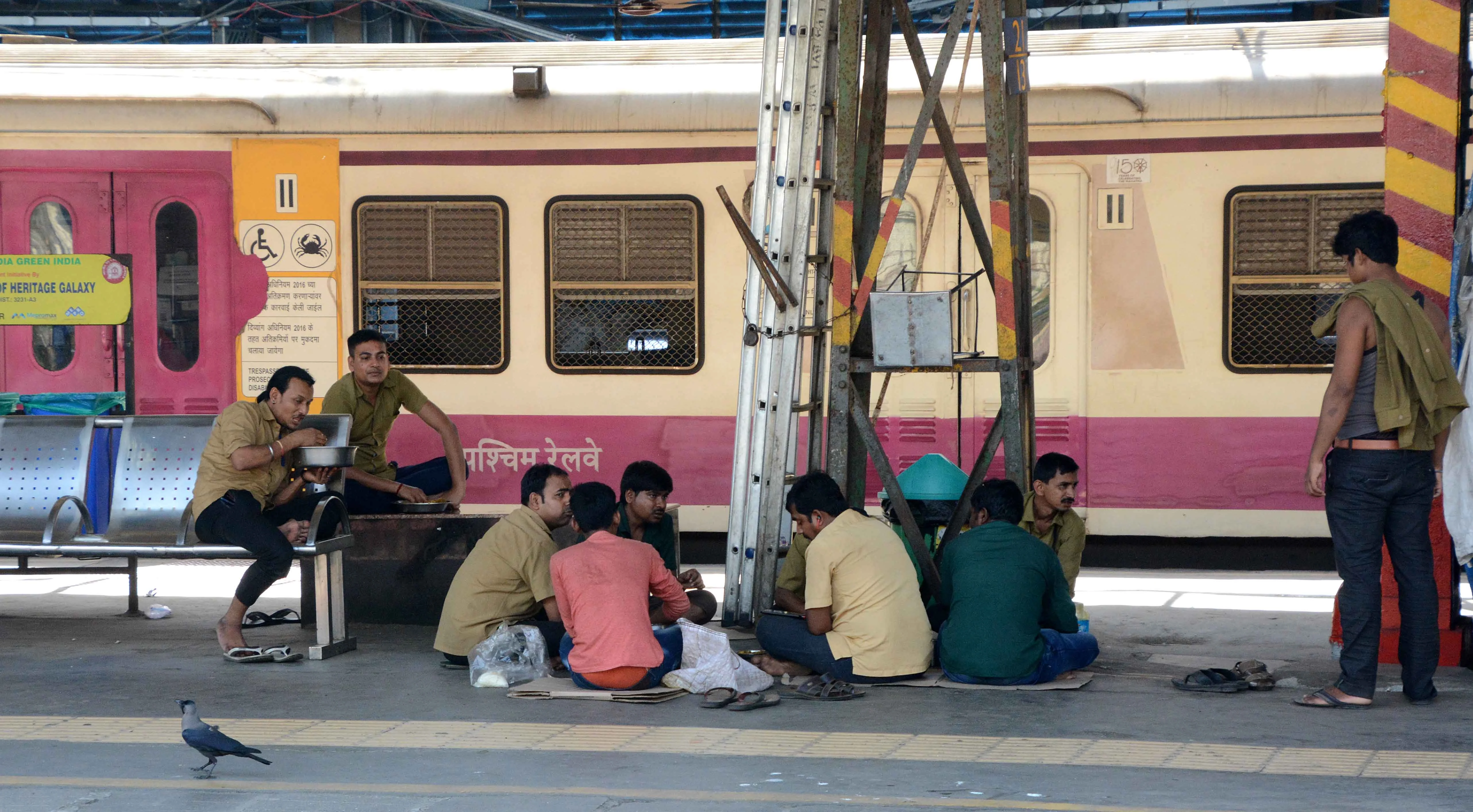Railway stall workers have lunch on a railway platform during lockdown in Andheri in Mumbai on Monday