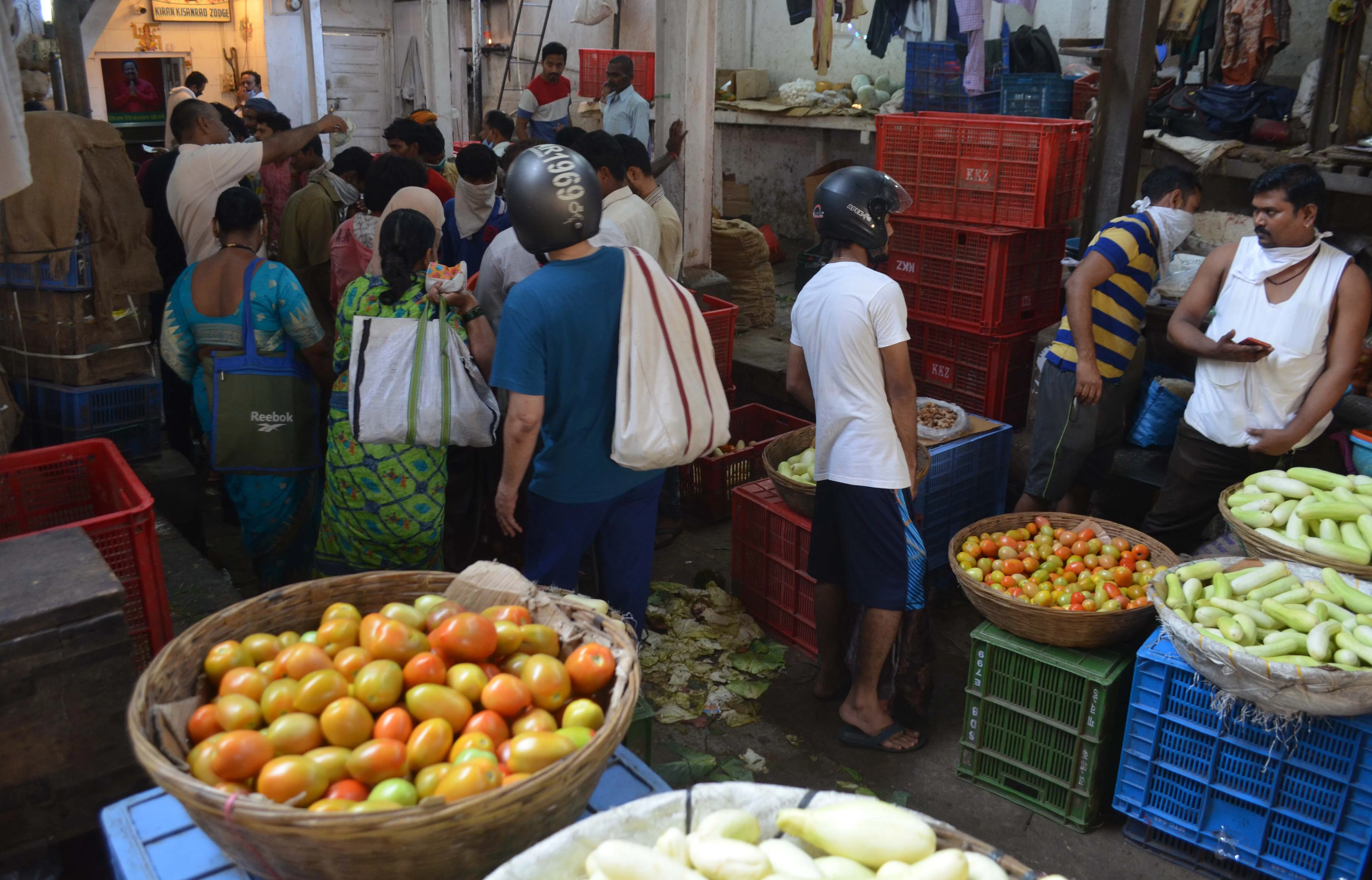 Consumers come out to buy vegetables at a Mumbai market.