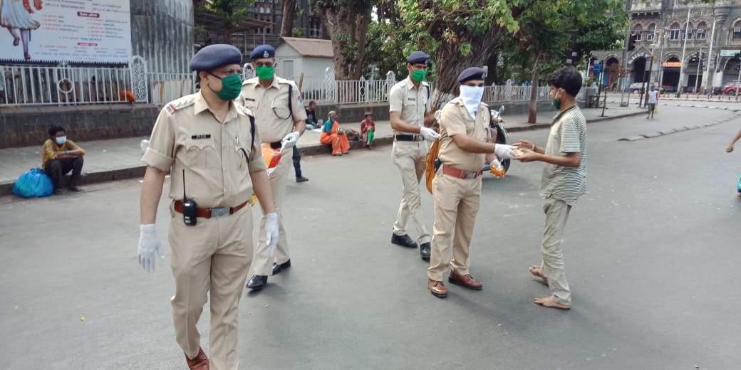 Police distributing food to the needy ones.