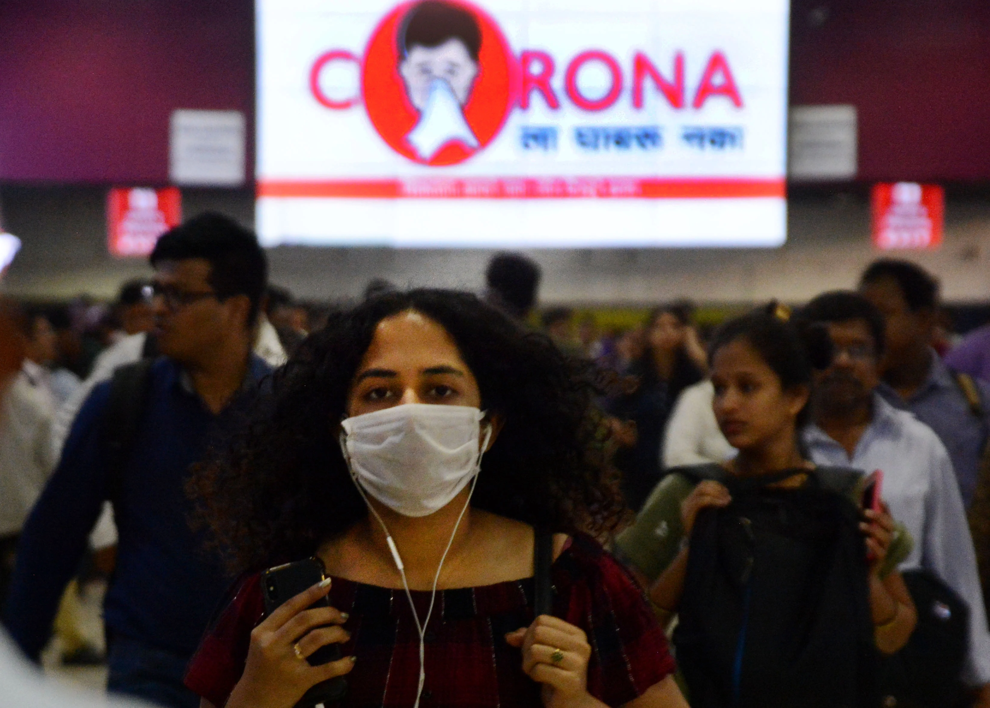 Railway passengers wearing masks at Churchgate Station