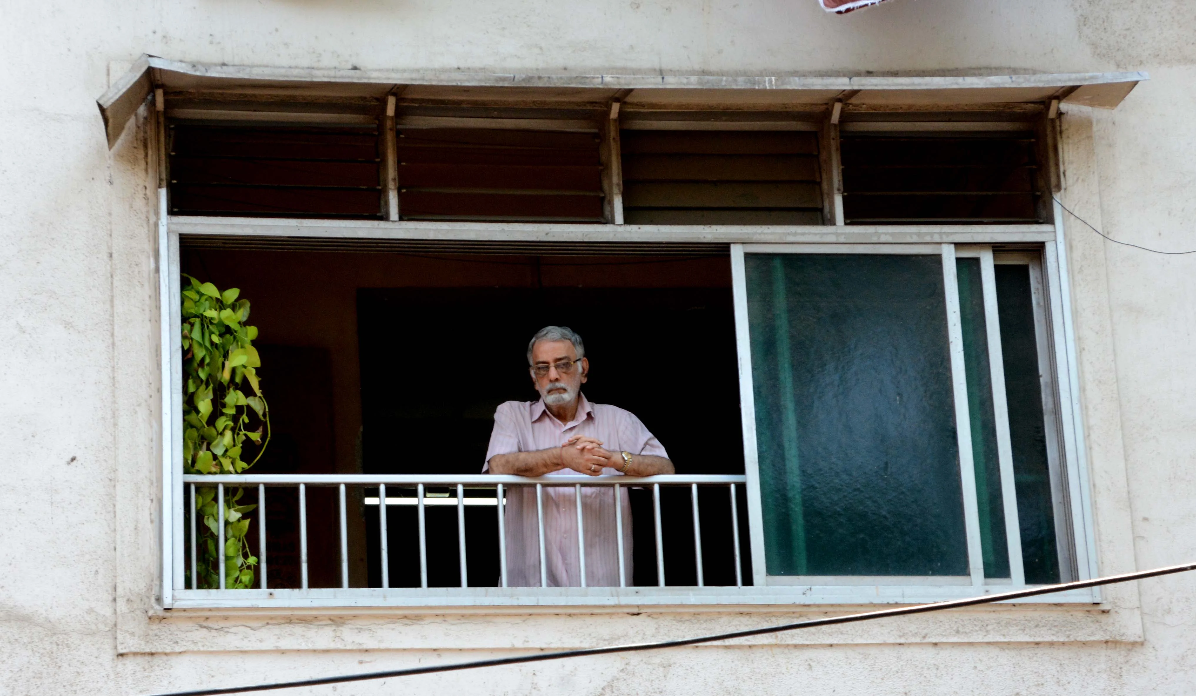 A man standing in his balcony at Grant Road during lockdown.