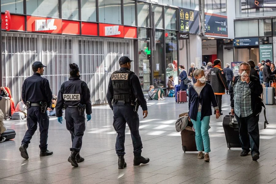 People wearing masks are seen at the Montparnasse train station in Paris, France, March 19, 2020.
