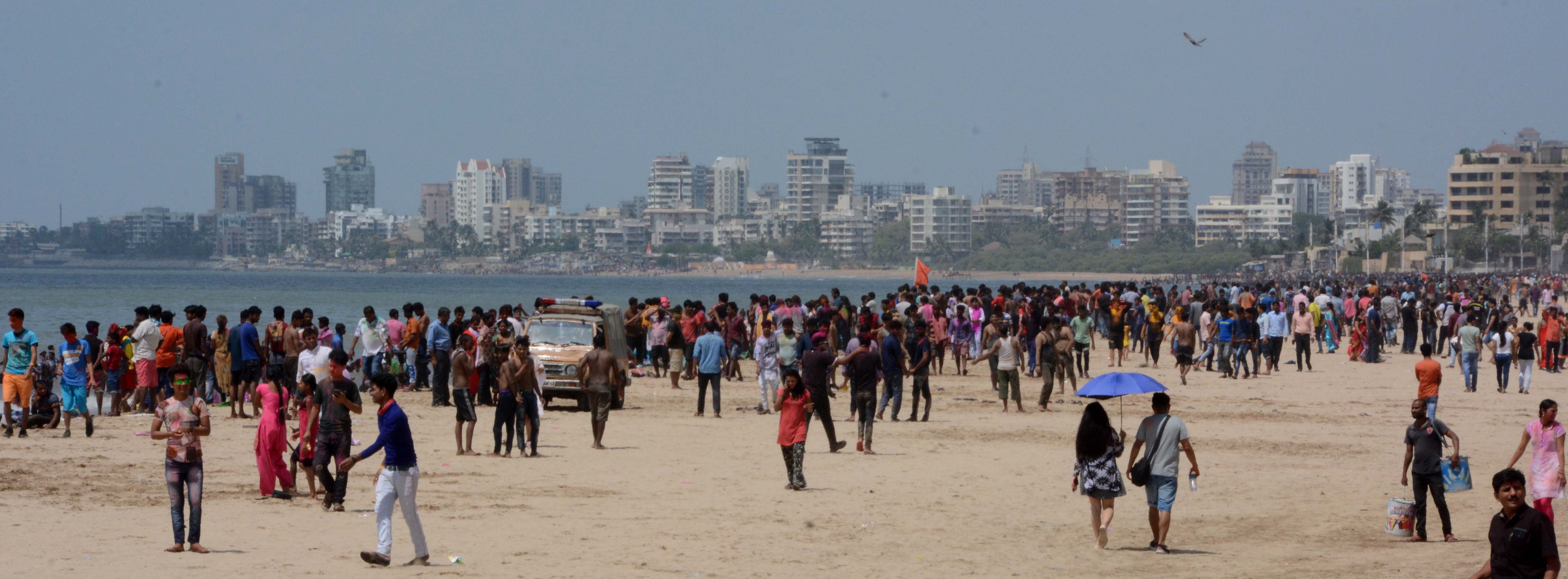People celebrate Holi at Mumbai's Juhu Beach