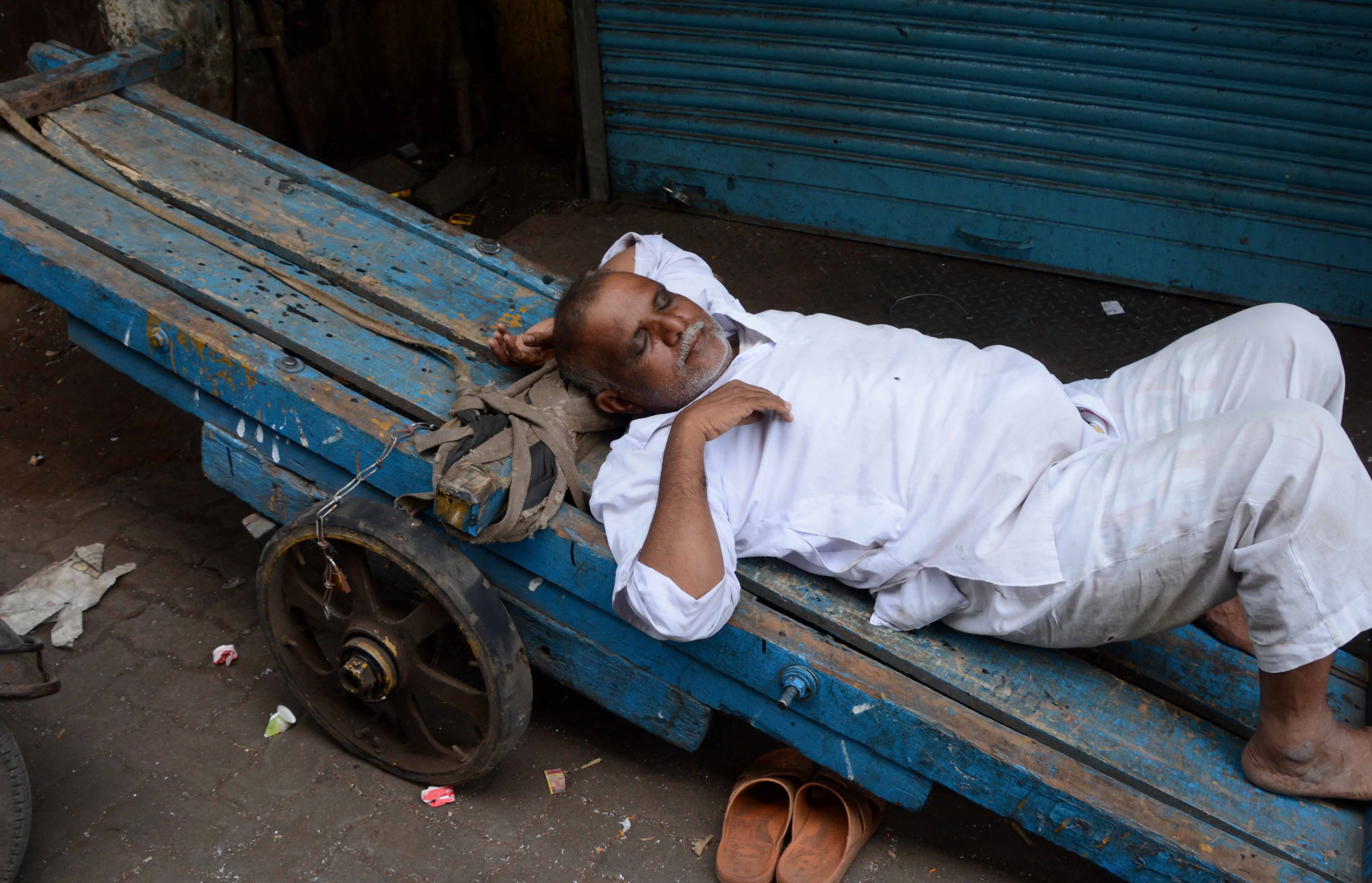 A worker relaxing since markets are closed in Grant Road.