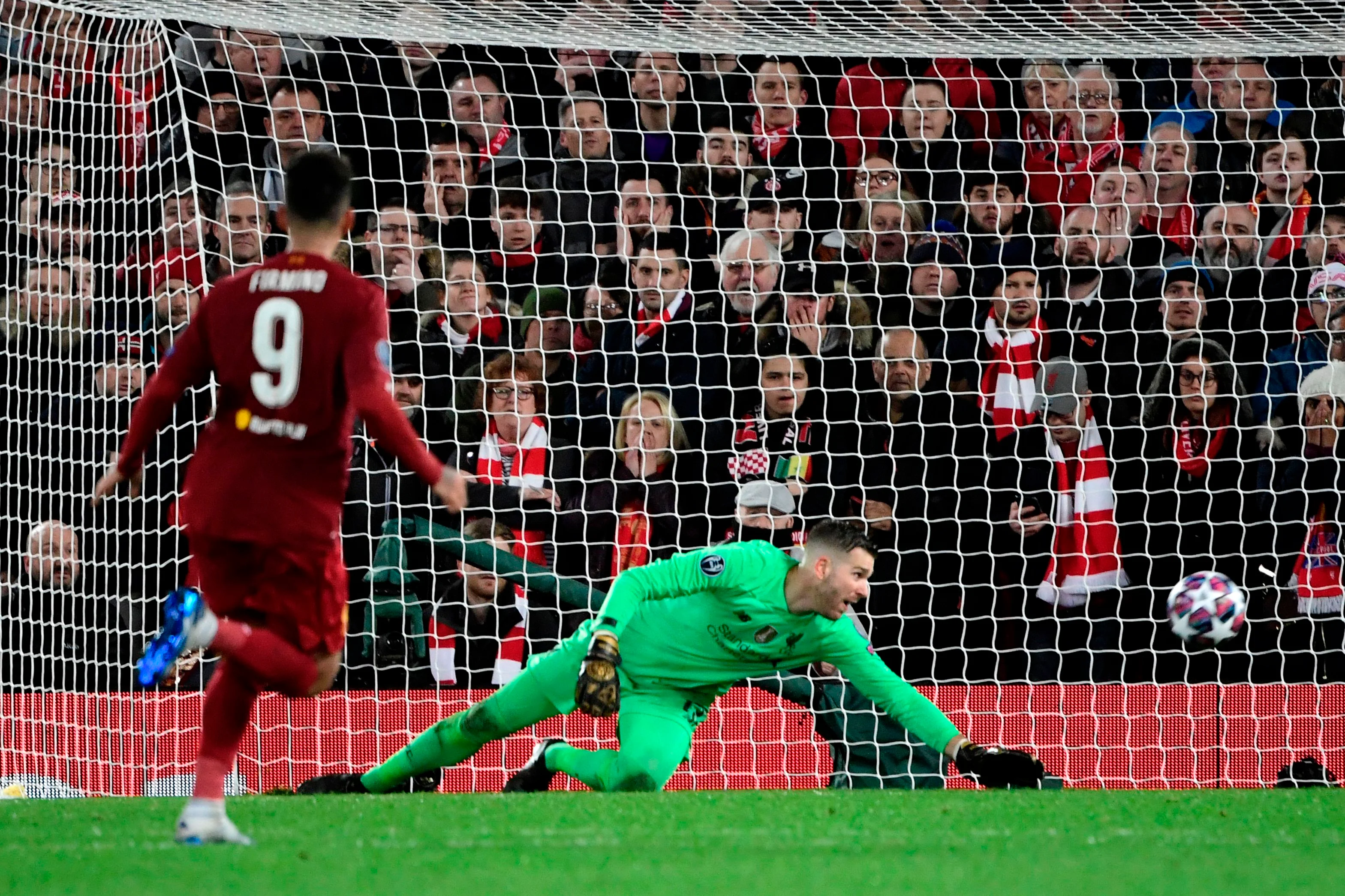 Liverpool's Spanish goalkeeper Adrian tracts as Atletico Madrid's Spanish midfielder Marcos Llorente scores his team's first goal.