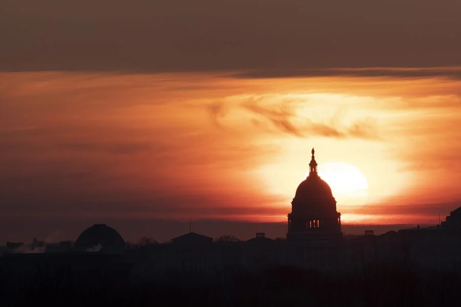 The U.S. Capitol Building is silhouetted against sunrise in Washington D.C., the United States, on March 18, 2020.