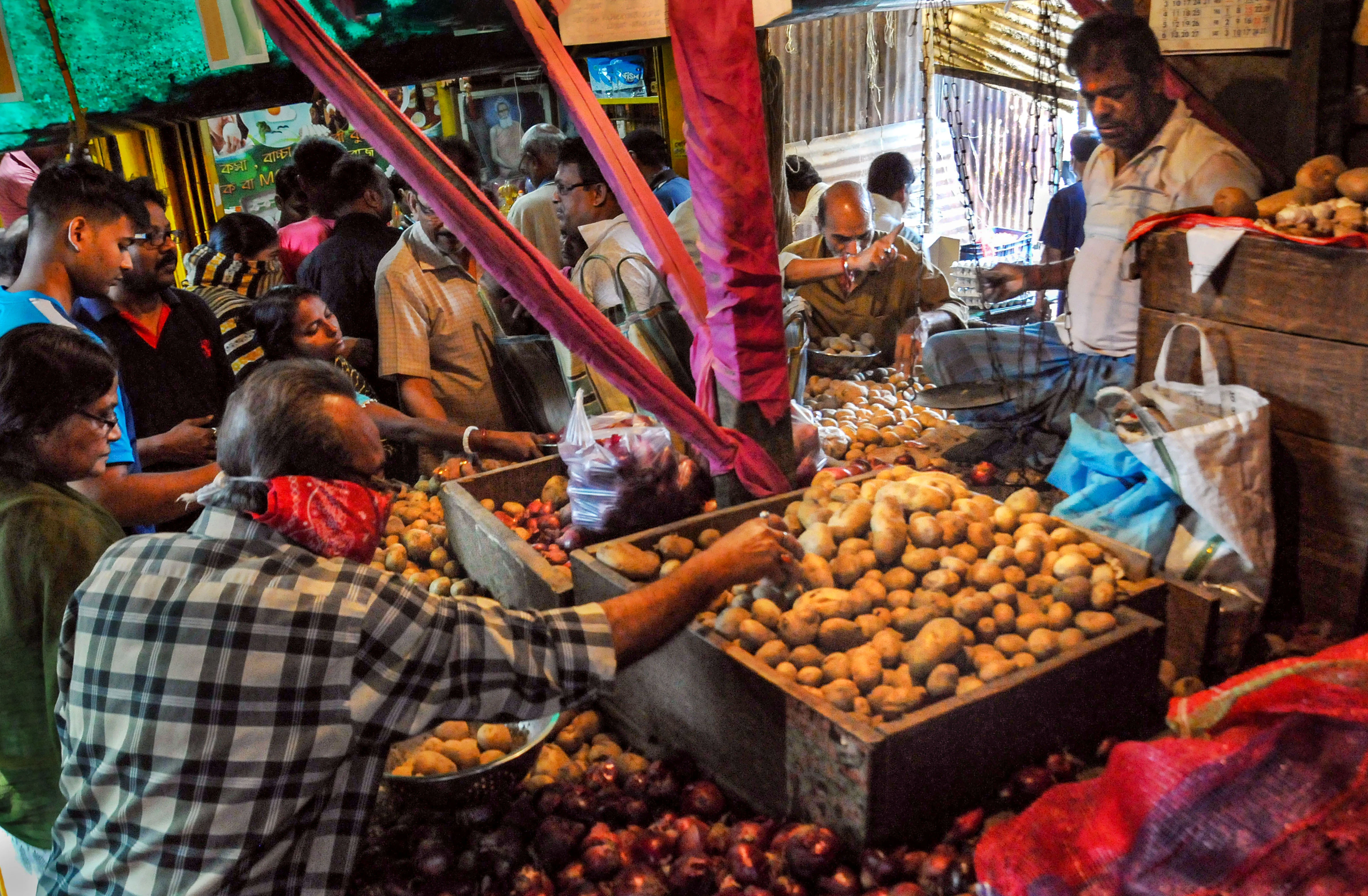 Locals buy vegetables before lockdown amid rising concerns over the coronavirus pandemic, in Kolkata, Monday, March 23, 2020.