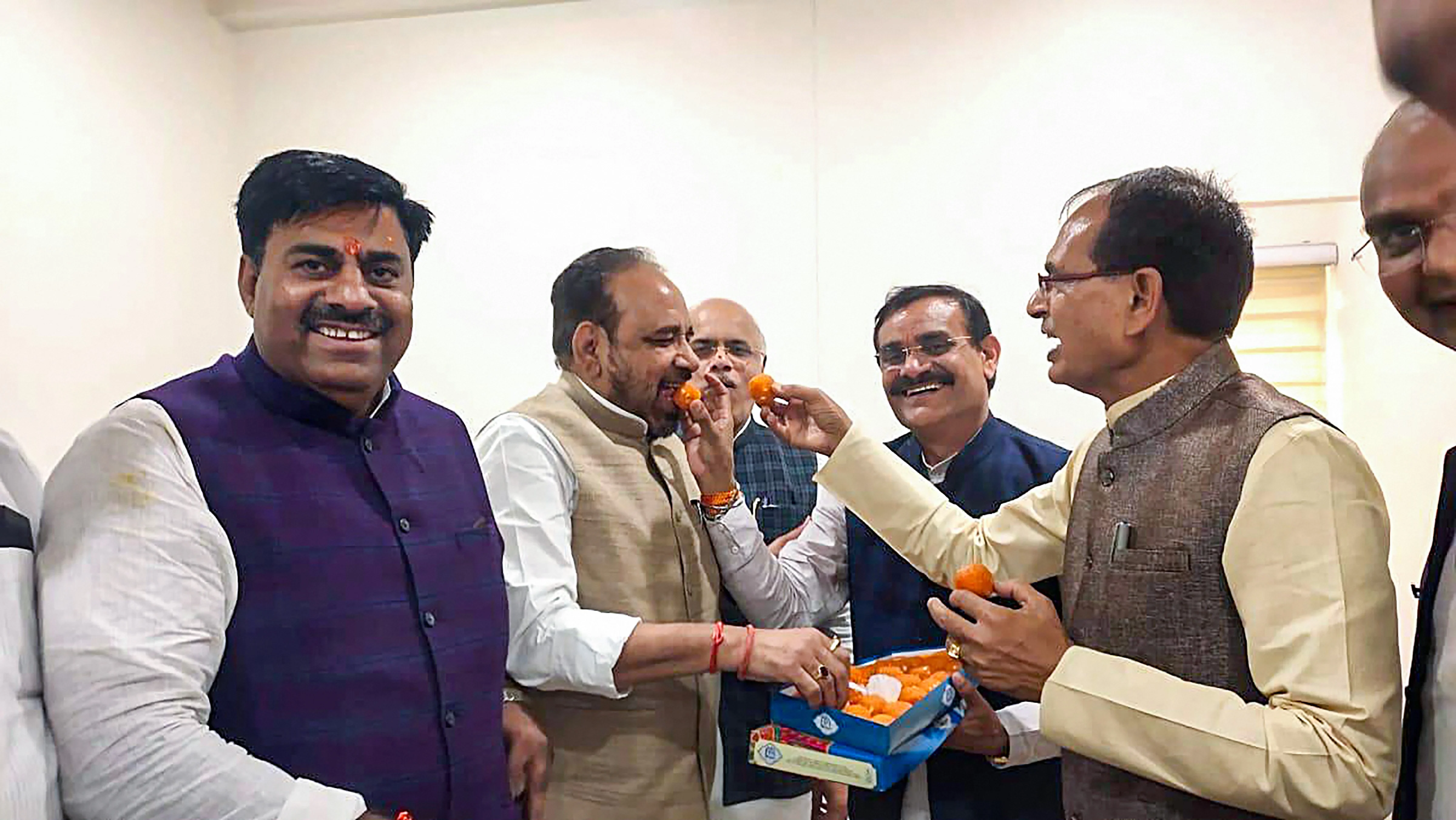 BJP National Vice President Shivraj Singh Chouhan and leader of the opposition in the State Assembly Gopal Bhargava with party MLAs celebrate after Chief Minister Kamal Nath resigned from his post, at BJP State headquarters in Bhopal.